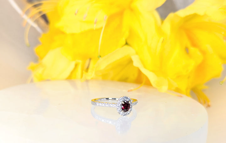 Ruby Unheated 0.25ct vivid red ruby on 18K white gold with a halo and band of 24 round collection diamonds at 0.28carats and 2.49 grams of gold.