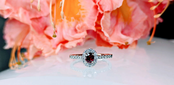 Ruby Unheated 0.25ct vivid red ruby on 18K white gold with a halo and band of 24 round collection diamonds at 0.28carats and 2.49 grams of gold.