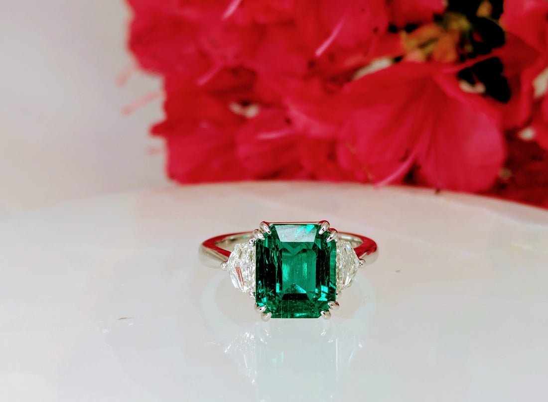Emerald 3.87 cts Zambian Octagon cut Emerald with minor oil with 2 pieces of 0.60ct shield cut diamonds on 18K white gold 4.61 grams (certified). "Price Available On Request"