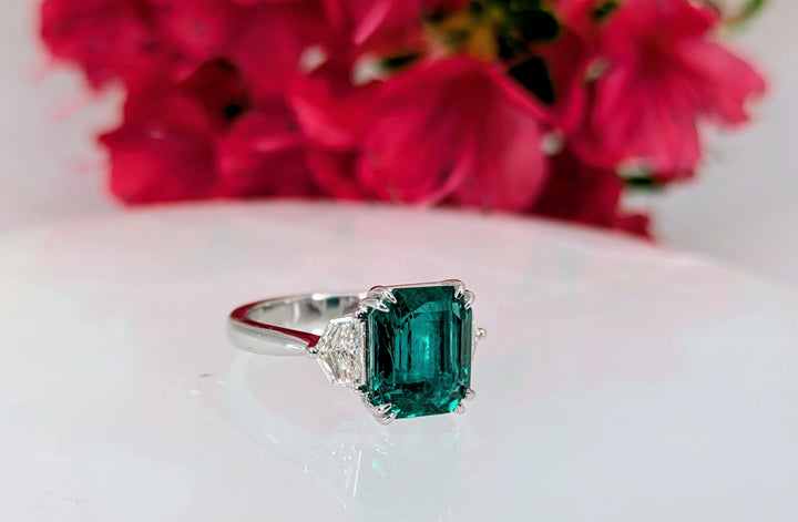 Emerald 3.87 cts Zambian Octagon cut Emerald with minor oil with 2 pieces of 0.60ct shield cut diamonds on 18K white gold 4.61 grams (certified). "Price Available On Request"